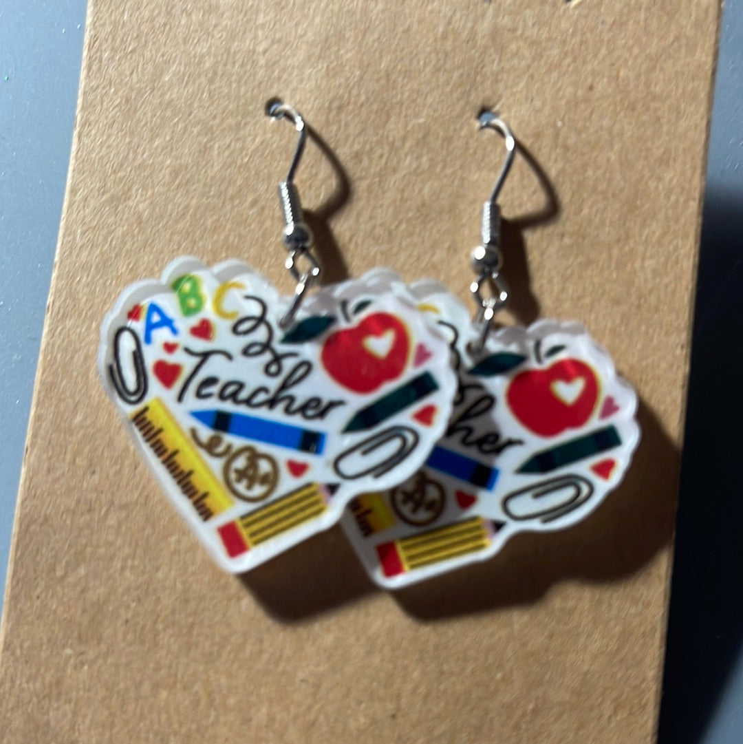 Teacher in heart with supplies earrings on